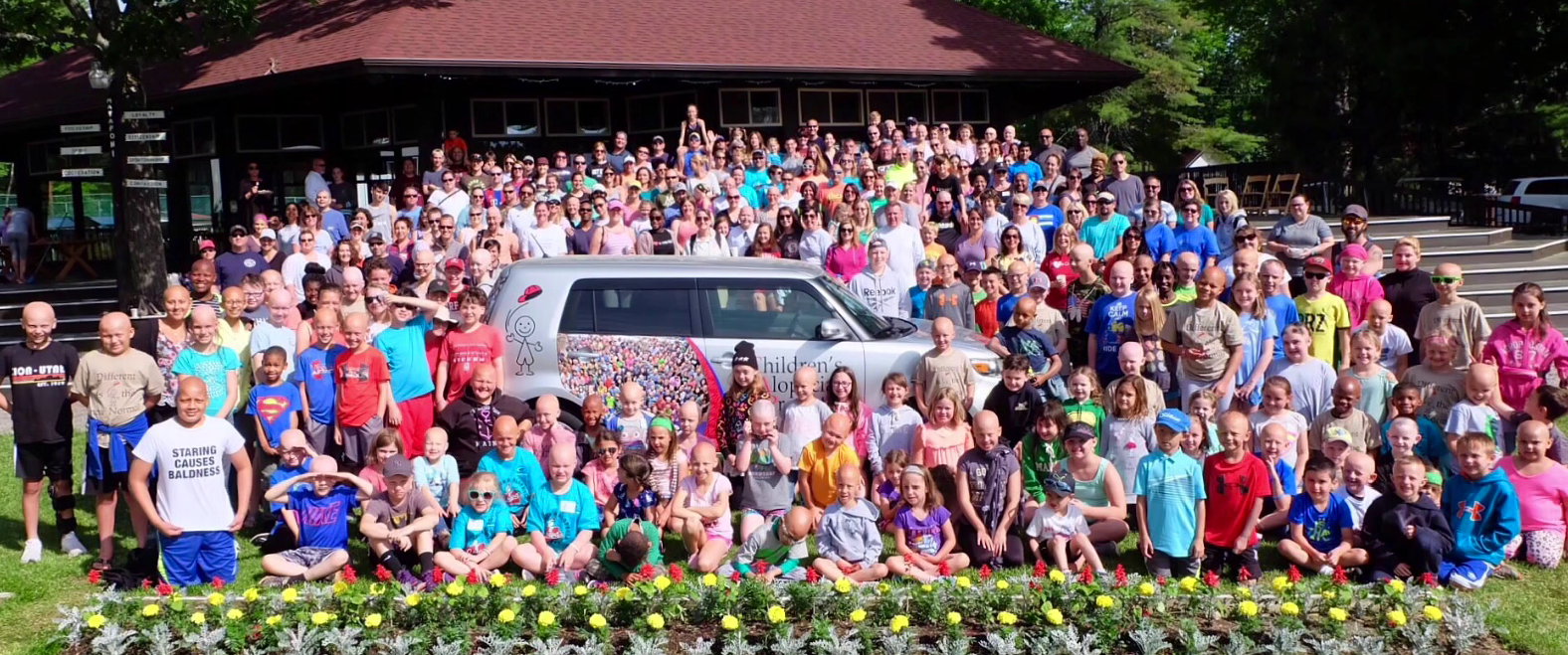 CAP families gathered for a group photo beside the CAP-branded car